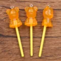 Orange luminous bear lollipop resin pendant DIY acrylic accessory for phone charm bag decor. - Orange