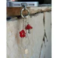 Detailed shot of cute red mushroom and flower metal phone charm pendant with snake chain aesthetic. - Red Mushroom Snake Bone Chain Pendant / Red