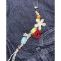 Beaded phone charm detail shot, colorful floral elements, handmade aesthetic strap for bags. - Off-White Floral Charm