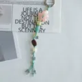 Detailed close-up view of the aesthetic beaded phone charm featuring cute floral and wooden accents. - Pink Blue Floral Isle Charm
