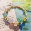 Handmade macrame woven crystal flower bracelet with net pocket and colorful bead details. - Flowers and Sea Cord Bracelet