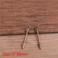 Mini alloy arrow pendant detail shot, vintage bronze weapon charm for DIY jewelry making. - Antique Bronze
