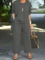 Outdoor detailed view of a stylish grey three-piece pants set featuring a matching cardigan. - 3XL / Set / Dark Gray