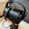 Black pillow bag, stylish commuter shoulder handbag with gold hardware and top handle variant. - Solid Black