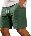 Detail view of textured fabric, elastic drawstring waist, and pockets on mens summer shorts. - S / Bottoms / Navy Blue