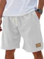 Close-up detail of men's casual linen-blend shorts featuring an elastic drawstring and pocket. - 3XL / Bottom (A626) / White