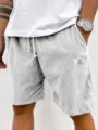 Detailed view of men's casual corduroy shorts with drawstring and stylish leg patch design. - S / Bottoms / White