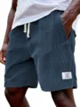Men corduroy shorts detail showing thick stripes, drawstring waist and stylish patch. - S / Bottoms / Army Green