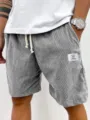 Detail shot of men's casual corduroy shorts, featuring white drawstring and pocket label. - S / Bottoms / Light Gray