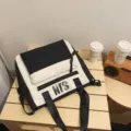 Black and white colorblock backpack with front pocket and top handles for daily school use. - Black Tutoring Bag with Pendant