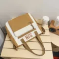Brown and white colorblock canvas backpack for students, stylish and large capacity daily school bag. - Khaki Tutoring Bag with Pendant