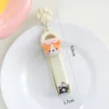 Süßer Cartoon Welpe faltbarer Nagelknipser mit Pfoten Anhänger tragbares Nagelwerkzeug - Orangefarbener Hund