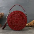 Vintage embossed round leather handbag for women, elegant red crossbody shoulder bag main view. - Burgundy