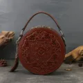 Retro embossed brown round leather handbag with top handle and tassel pendant accessory variant - Brown