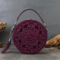 Vintage embossed purple round leather handbag with elegant cut-out pattern and chic tassel charm. - Purple