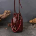 Handmade genuine leather bucket bag for women, retro drawstring crossbody shoulder bag with beads. - Coffee