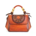 Vintage leather handbag with intricate embossed mandala design and unique bamboo handles. - Brown