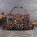 Vintage floral embroidered top handle bag with burgundy leather trim and classic metal clasp lock. - Golden Coffee