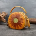 Vintage leather round handbag with sunflower embossed design, stylish women's crossbody bag. - Yellow