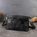Black leather crossbody bag with embossed floral pattern, stylish small shoulder bag for women. - Rose