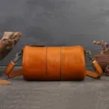 Vintage cylindrical leather shoulder bag for women, retro crossbody pillow bag with strap. - Brown