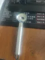 Stainless steel noodle slicer detail view, kitchen cooking tool with ergonomic handle and hanging loop. - Round Tube Handle