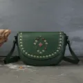 Green leather saddle bag with vintage metal rivets and gemstone detail for women crossbody. - Green