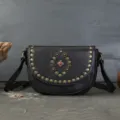 Black leather saddle bag with vintage metal studs and central gemstone, stylish crossbody shoulder bag. - Gray