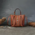 Retro vegetable-tanned cowhide leather bucket bag with chic rivets and braided handle. - Brown