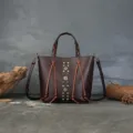 Genuine leather retro bucket bag with woven handle, stylish color-blocking and metal rivets. - Coffee