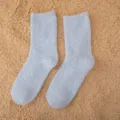 Detailed close-up of soft light blue fuzzy coral fleece sleep socks, cozy winter floor wear. - One Size / Light Blue