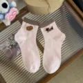 Cute pink cotton socks featuring adorable dachshund and hot dog embroidery with brown ribbed cuffs. - One Size / Pink