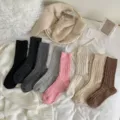 Detailed view of thick speckled cable knit slouch wool socks in cozy lifestyle flat lay. - ky Cable Knit Dark Grey