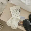 Cute women mid-calf socks featuring sweet heart jacquard patterns and chic bow cuff detail. - One Size / White