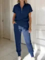 Gedetailleerd overzicht van de donkerblauwe sportset met rits en comfortabele joggingbroek. - 2XL / Top en Broek / Marineblauw