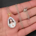 Close-up detail of the Jesus teardrop cross pendant necklace, featuring fine metal chain work. - A Teardrop Style