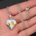 Detailed view of the silver heart pendant necklace with religious art, showing the fine chain. - B Heart Style