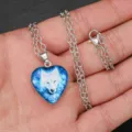 Close-up detail of the men's blue glowing wolf totem heart pendant necklace on display. - Blue Luminous Wolf Totem Style (AA371)