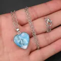 Detailed close-up of the silver heart wolf pendant necklace, showing the exquisite glass dome design. - Snow Wolf Style (AA300)