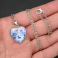 Close up view of the silver heart shaped pendant necklace featuring a beautiful crystal wolf design. - Ice Wolf Pack Style (AA305)