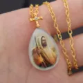 Gold cross teardrop pendant necklace with sparkling crystal and religious portrait design. - C Teardrop Style