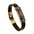 Men's vintage brown leather bracelet with antique brass metal alloy clasp and engraved centerpiece. - Clover