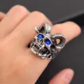 Detailed closeup shot of punk satanic ram skull ring with blue crystal eyes for men and women. - Size 7 / Blue