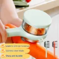 Multifunctional vegetable peeler with storage box, stainless steel blade for kitchen use. - Light Green