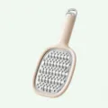 Stainless steel kitchen grater with beige handle, cheese and vegetable shredder tool. - Grater / Cream