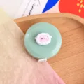 Cute cartoon mini tape measure, portable retractable soft measuring tape for body sizing. - Green Background Lamb Tape Measure