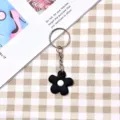Portachiavi fiore nero stile ins coreano con centro bianco, ciondolo in metallo. - Stile Cerchio Argento / Nero Fiore Piccolo