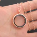 Close-up of a rose gold round floating memory locket pendant necklace, delicate chain. - Cross Chain 60cm / Rose Gold