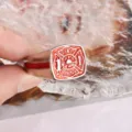 Vintage firefighter theme metal ring with red enamel and cross logo detail close up view - Size 8 / Red