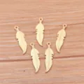 Detailed view of small gold feather metal charms, ideal for DIY bracelets and necklaces. - KC Gold